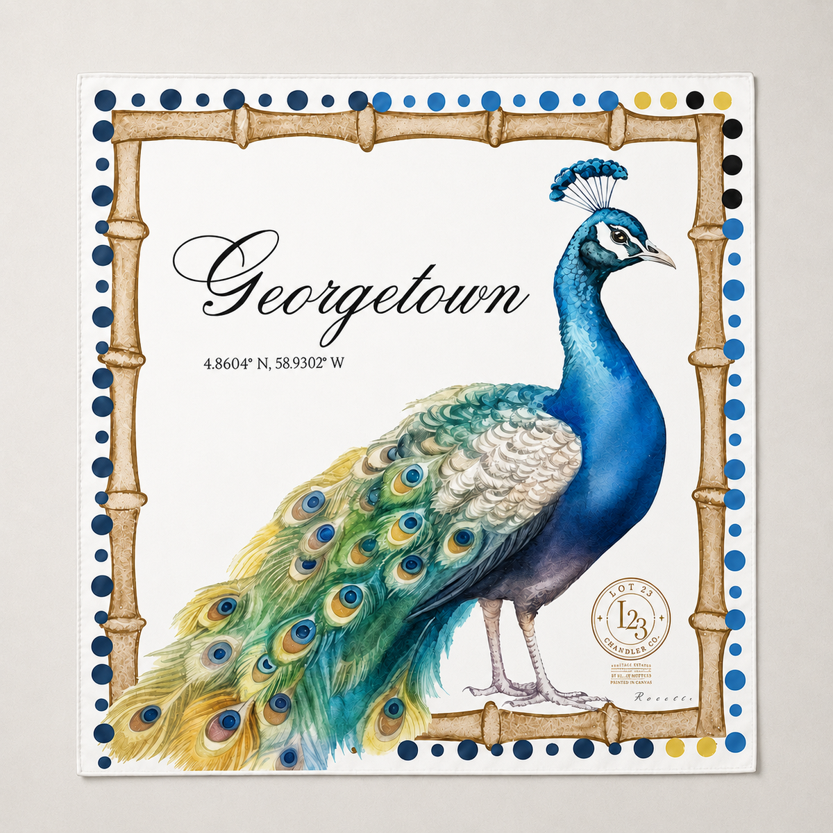 A square decorative print featuring a painted peacock with a bright blue neck and green-and-blue tail, framed by a bamboo-style border with blue dots. The word 'Georgetown' appears in script, with coordinates beneath it and a circular seal near the lower right.